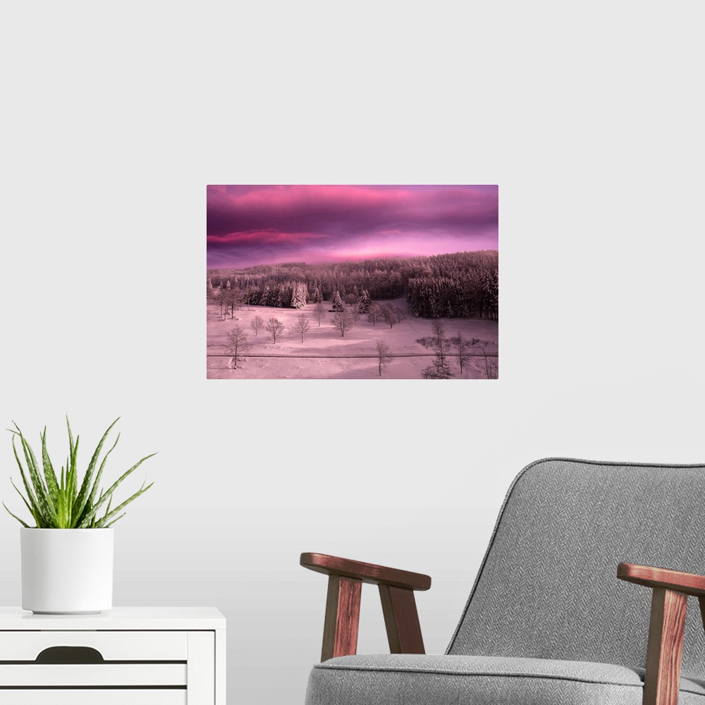 A modern room featuring Sunset over a snowy landscape