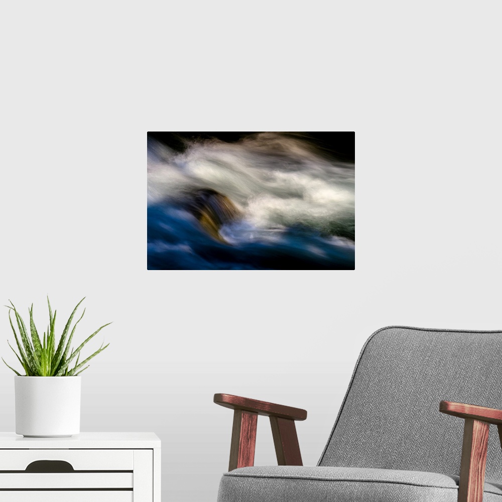 A modern room featuring A photo of rushing water with foam that has been edited to a smooth effect.