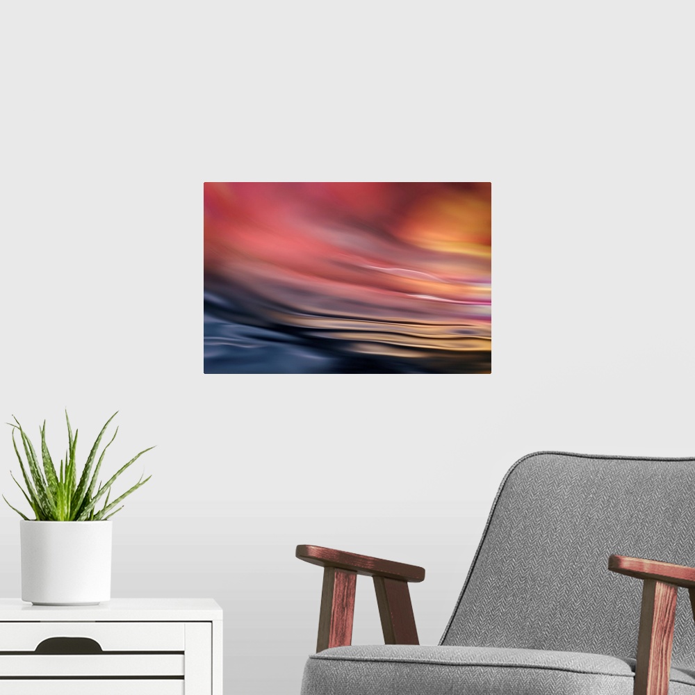 A modern room featuring Abstract photograph of softly rippling water in red and orange tones.