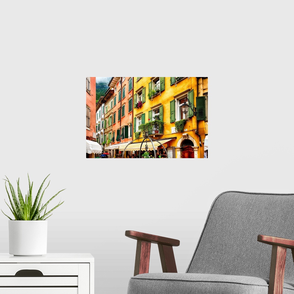 A modern room featuring Fine art photo of the brightly colored buildings and window shutters of an Italian street.