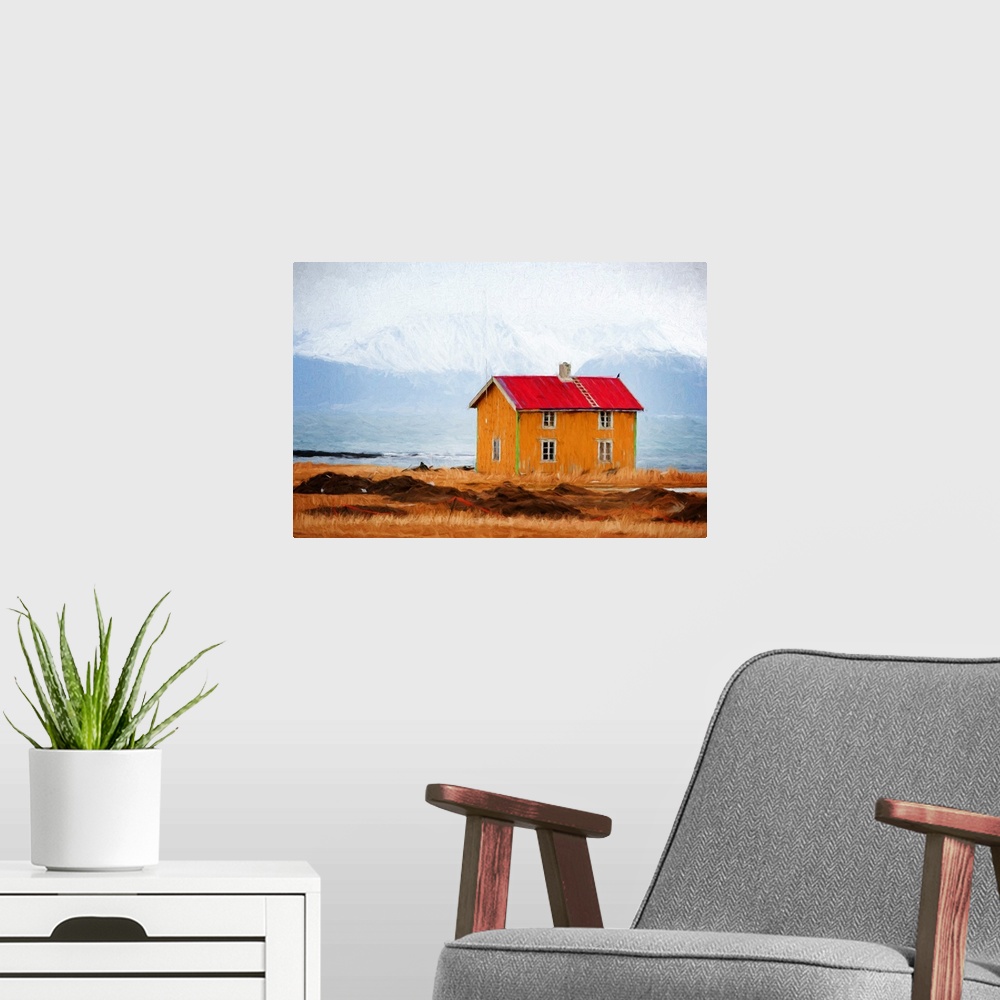 A modern room featuring A photograph of a red roofed building in a rugged mountainous landscape.
