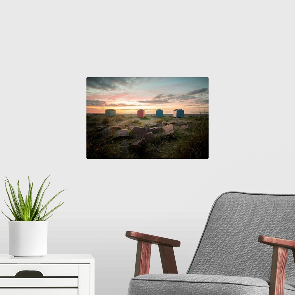 A modern room featuring A pink and orange sunset in Scotland on findhorn beach
