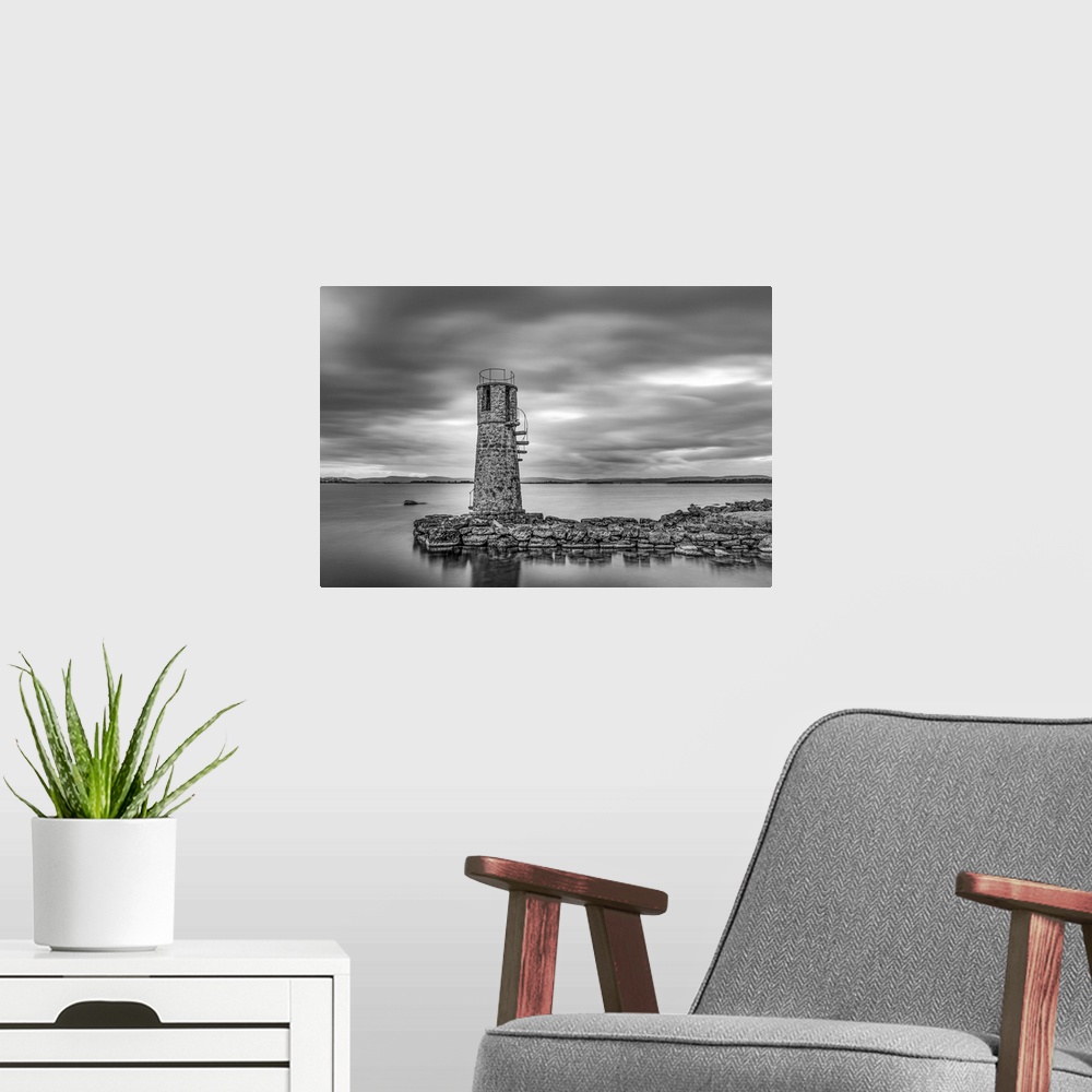 A modern room featuring Black and white photo of an old lighthouse by a lake
