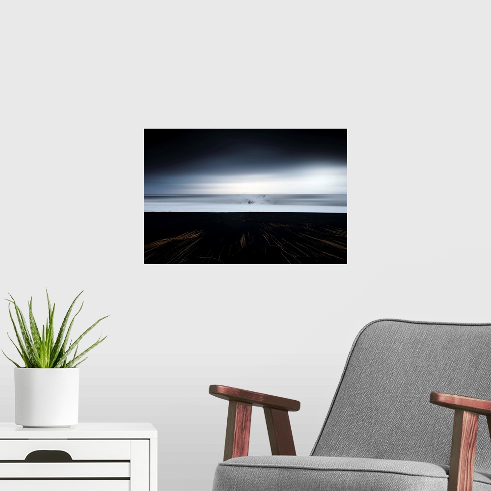 A modern room featuring Abstract photograph of a dark landscape with thin gold lines leading up to an ocean where a large...
