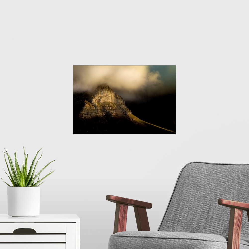 A modern room featuring A photograph of clouds rolling over a mountain peak.