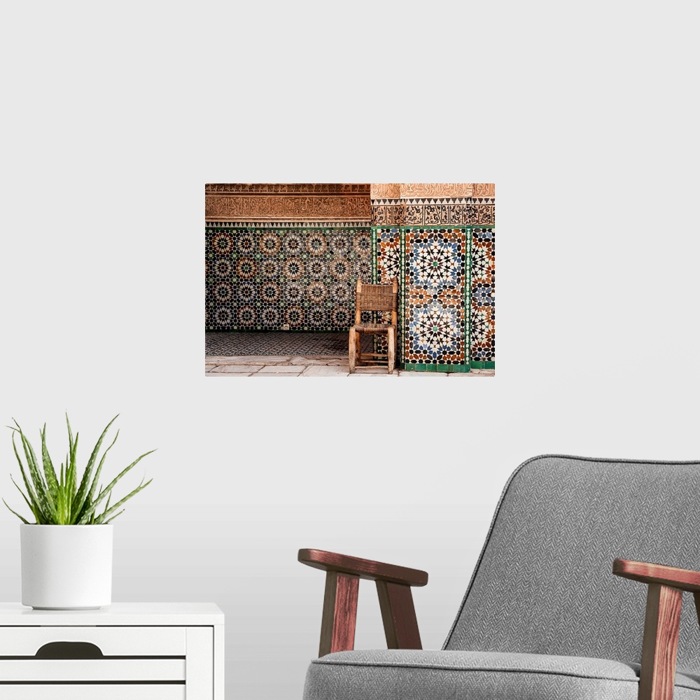 A modern room featuring Photograph of a wooden chair with a woven seat and back against beautifully tiled exterior walls.