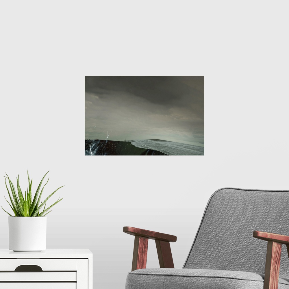 A modern room featuring Conceptual image of a restless ocean and the tide rolling in on an overcast day.