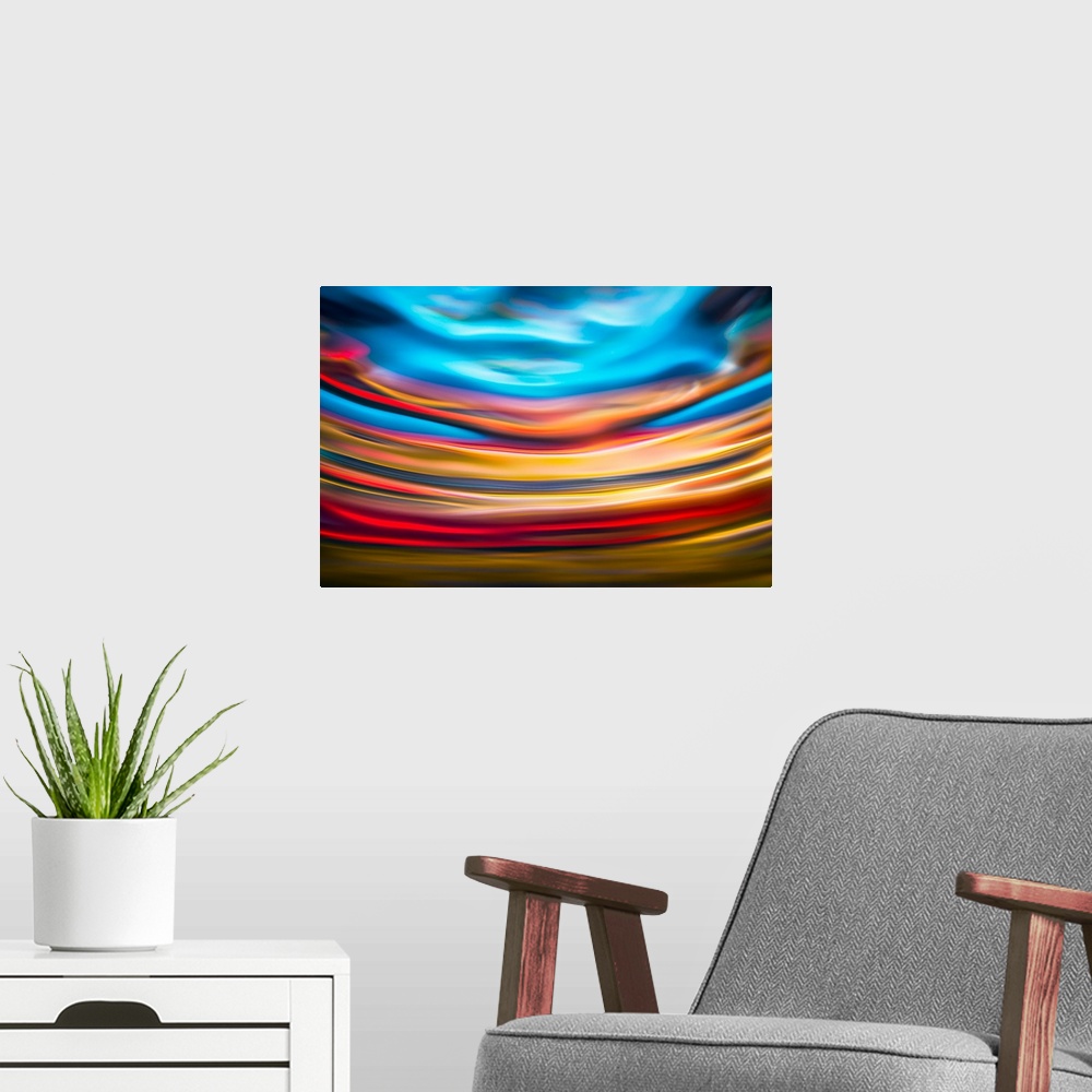 A modern room featuring Abstract photograph with arched lines in hues of yellow, red, and blue.