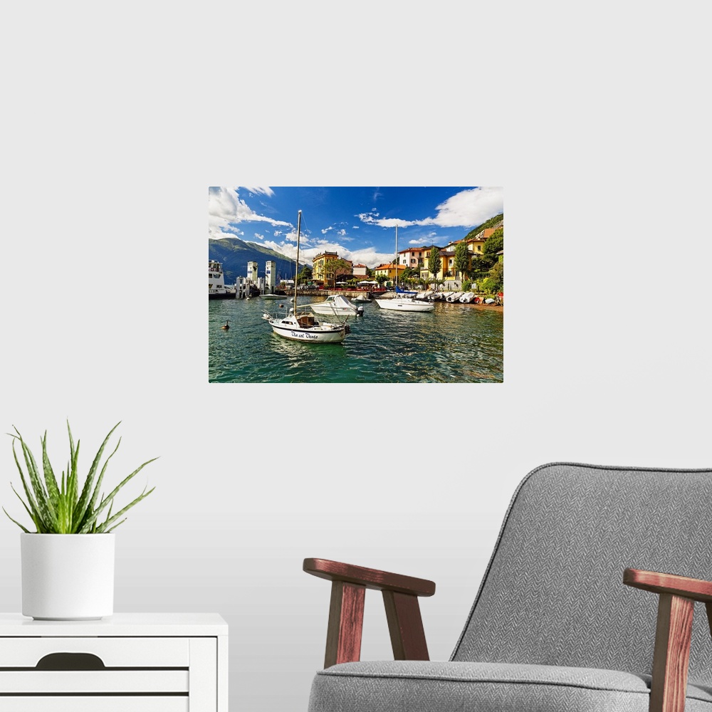 A modern room featuring A photograph of a coastal village harbor.