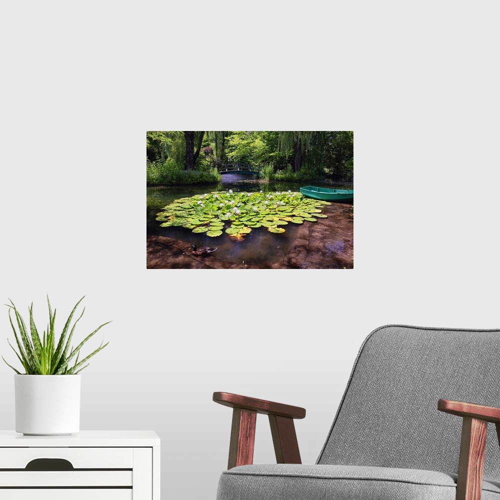 A modern room featuring A photograph of a pond with lily pads sitting on the surface of the water.