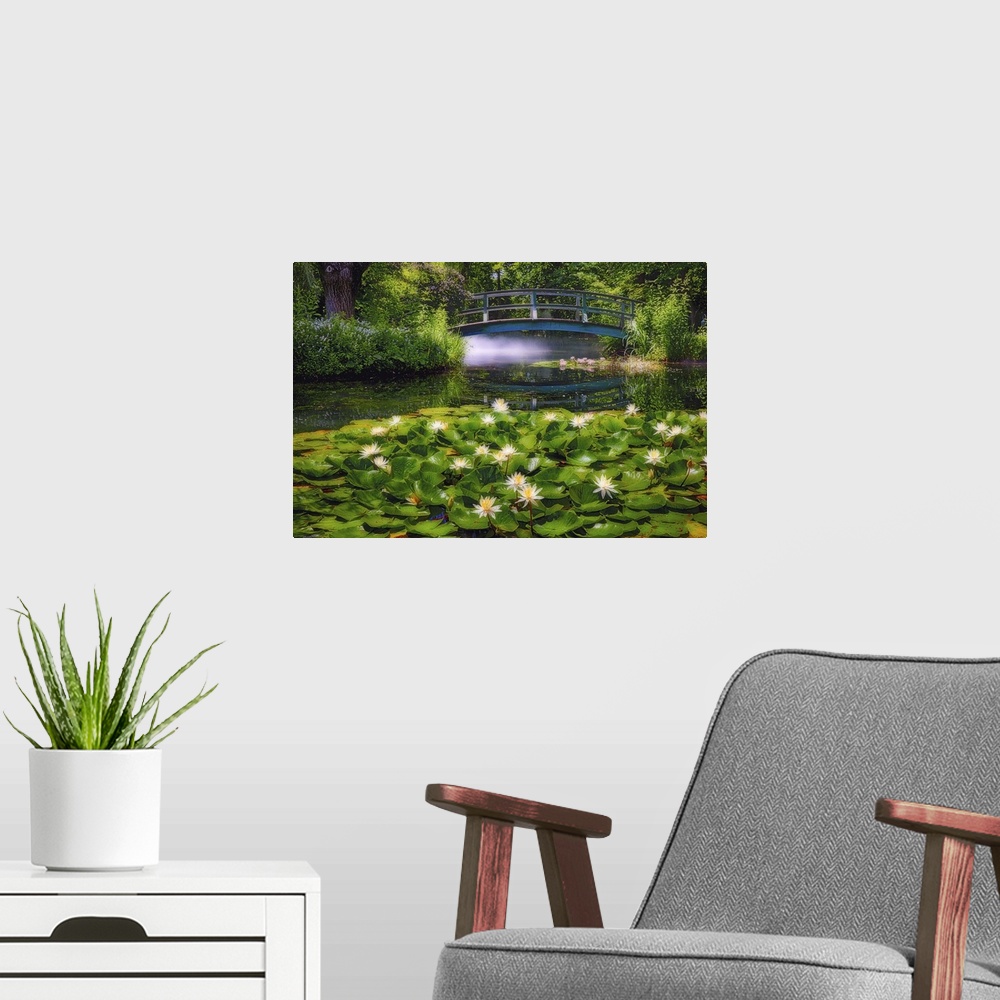 A modern room featuring A photograph of a pond with lily pads sitting on the surface of the water.