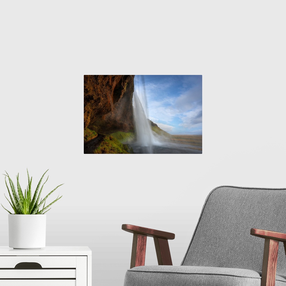 A modern room featuring Fine art photograph of a tall waterfall in Iceland.