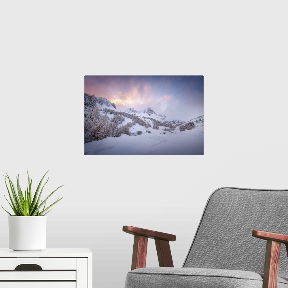 A modern room featuring Colored sunset landscape scene on a snowy mountain in the Alpes in France. A pine valley in winte...
