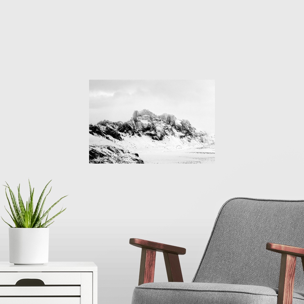 A modern room featuring A photograph of a rugged winter landscape.