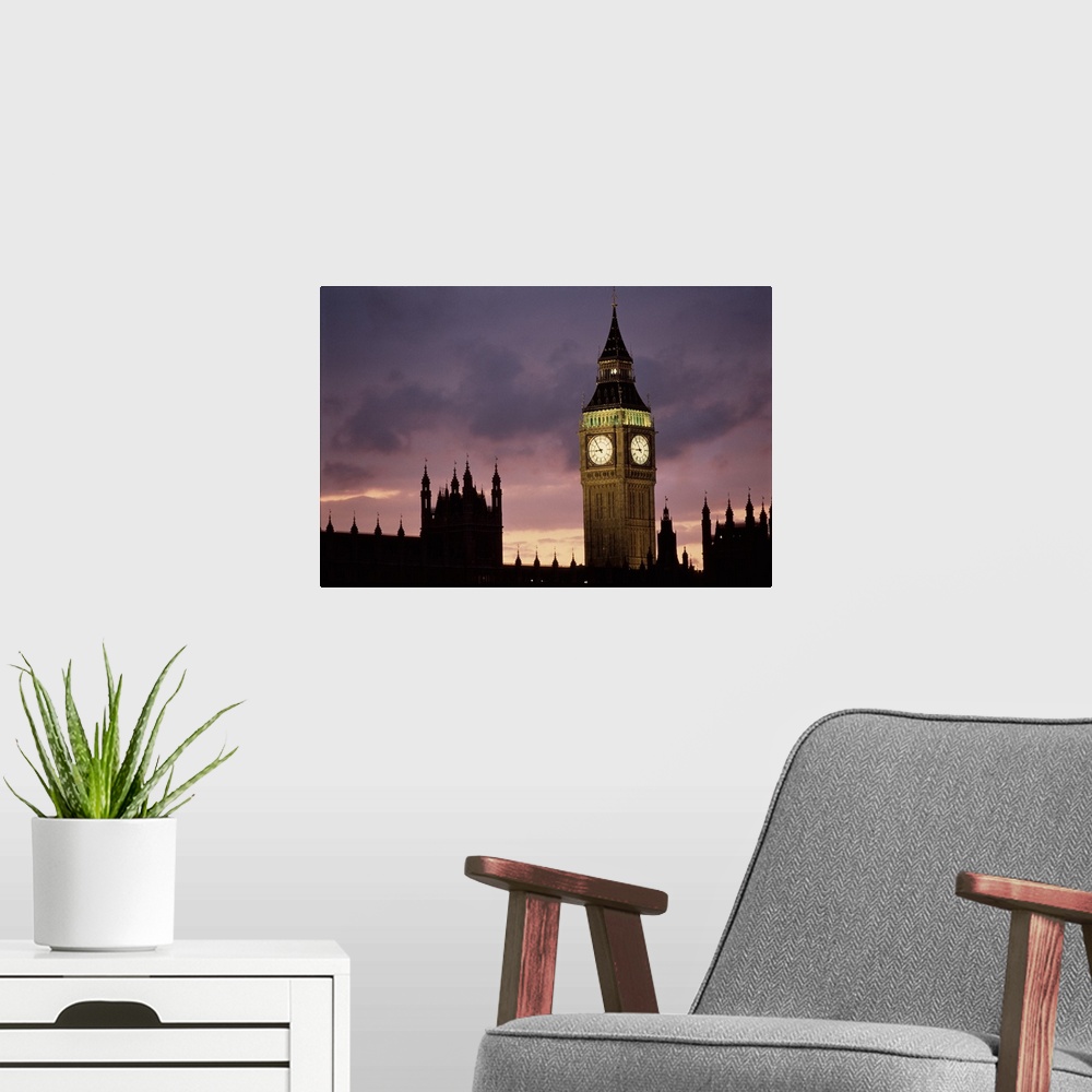 A modern room featuring A lit up Big Ben clock exends in to the dusk London sky rising high above the spires of Parlament...