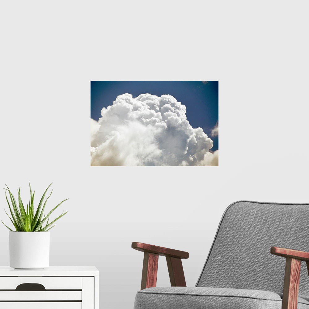 A modern room featuring Billowing white clouds, blue sky.
