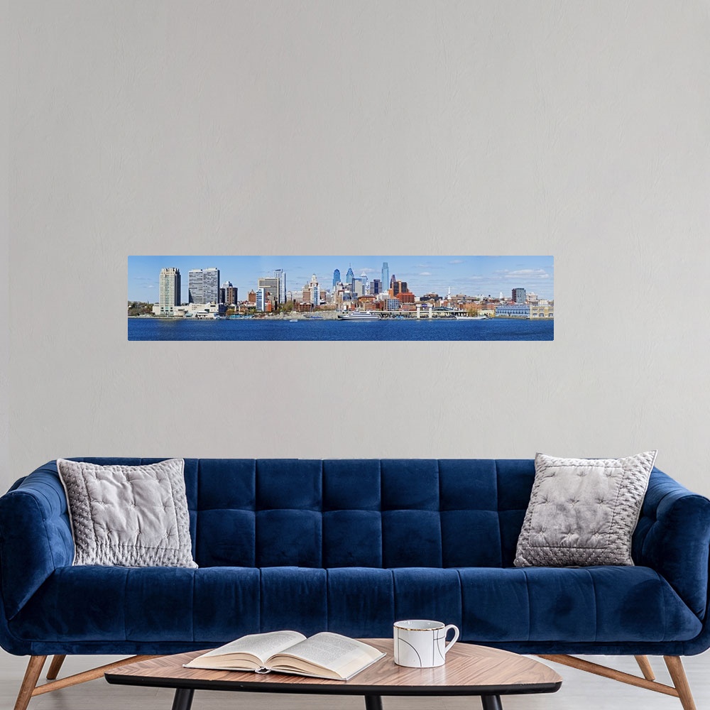 A modern room featuring A panoramic photograph taken of the Philadelphia skyline during the day from just across the Dela...