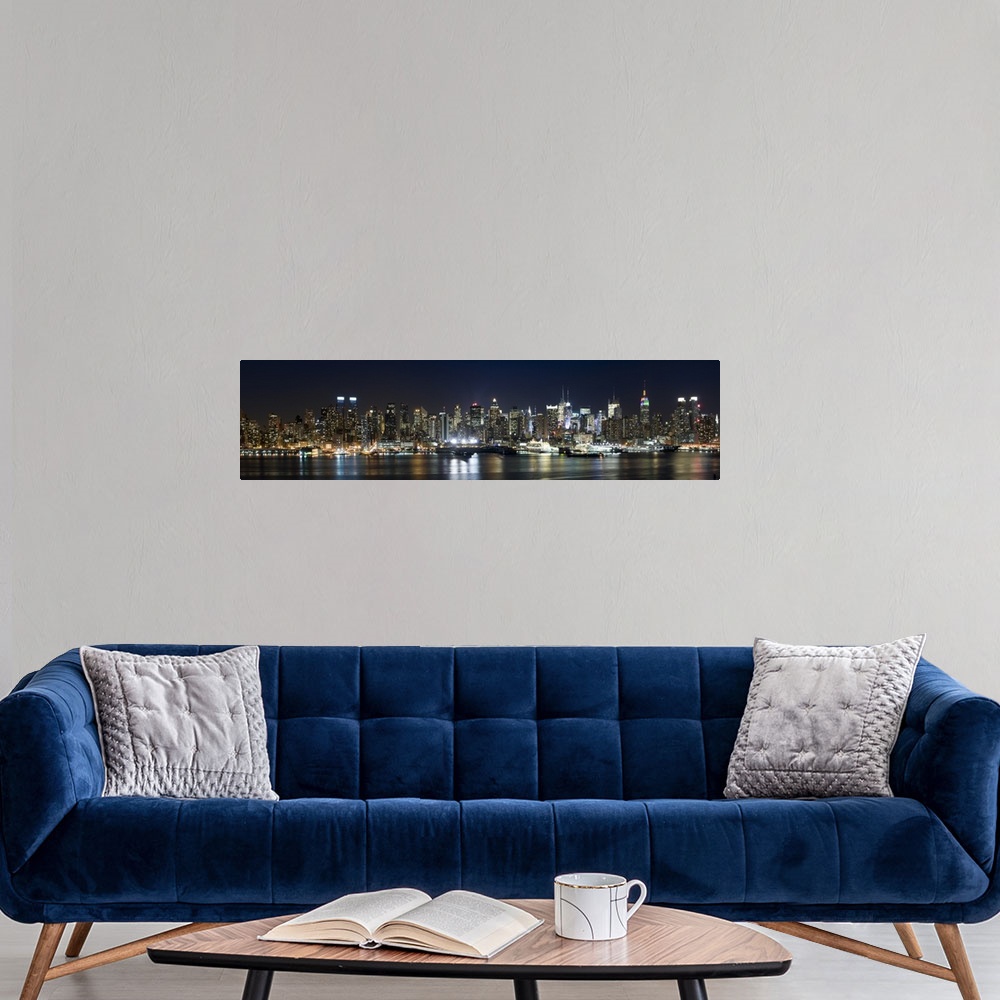 A modern room featuring Panoramic photograph of city skyline at dusk with the building lights reflected in the waterfront.