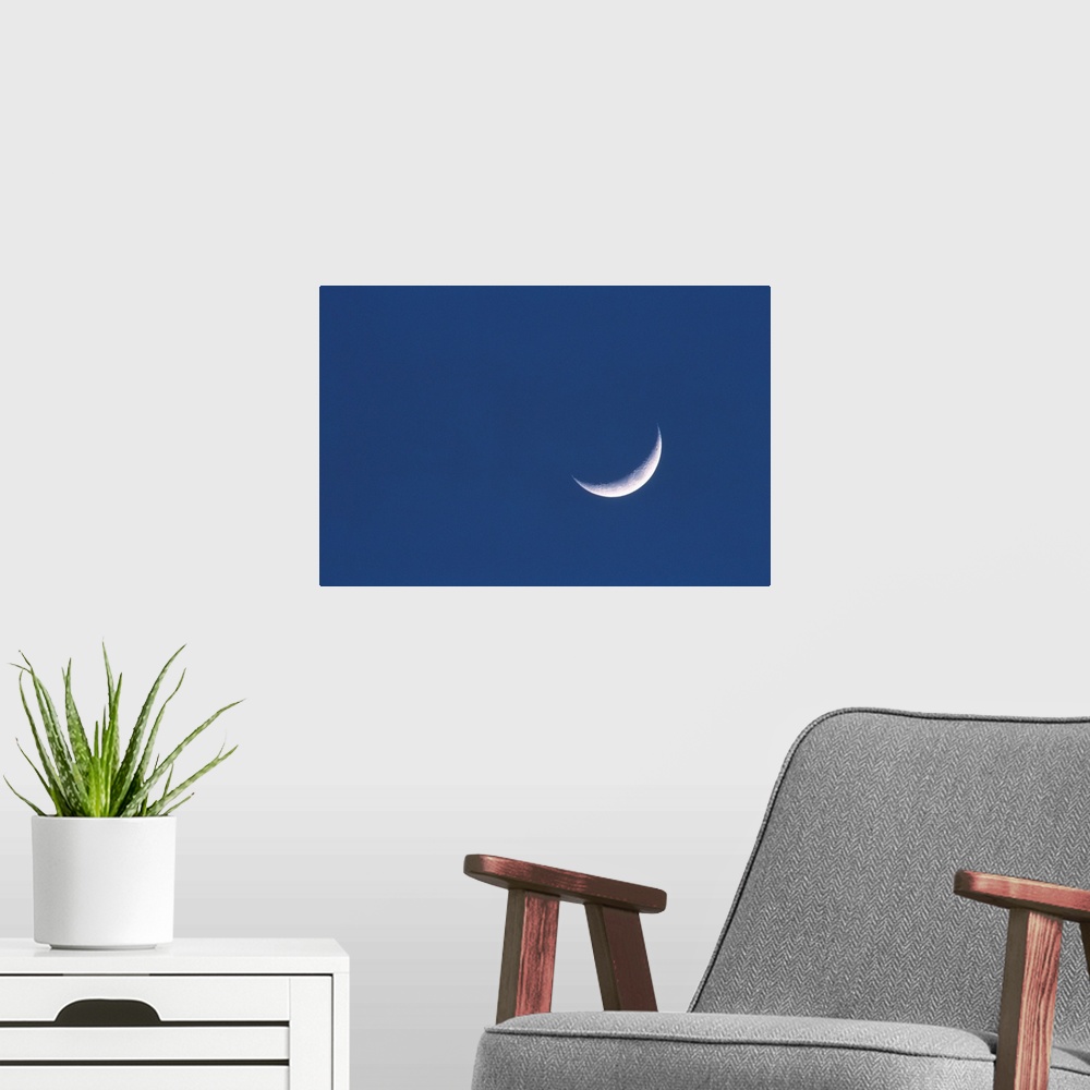 A modern room featuring Crescent moon in deep blue sky