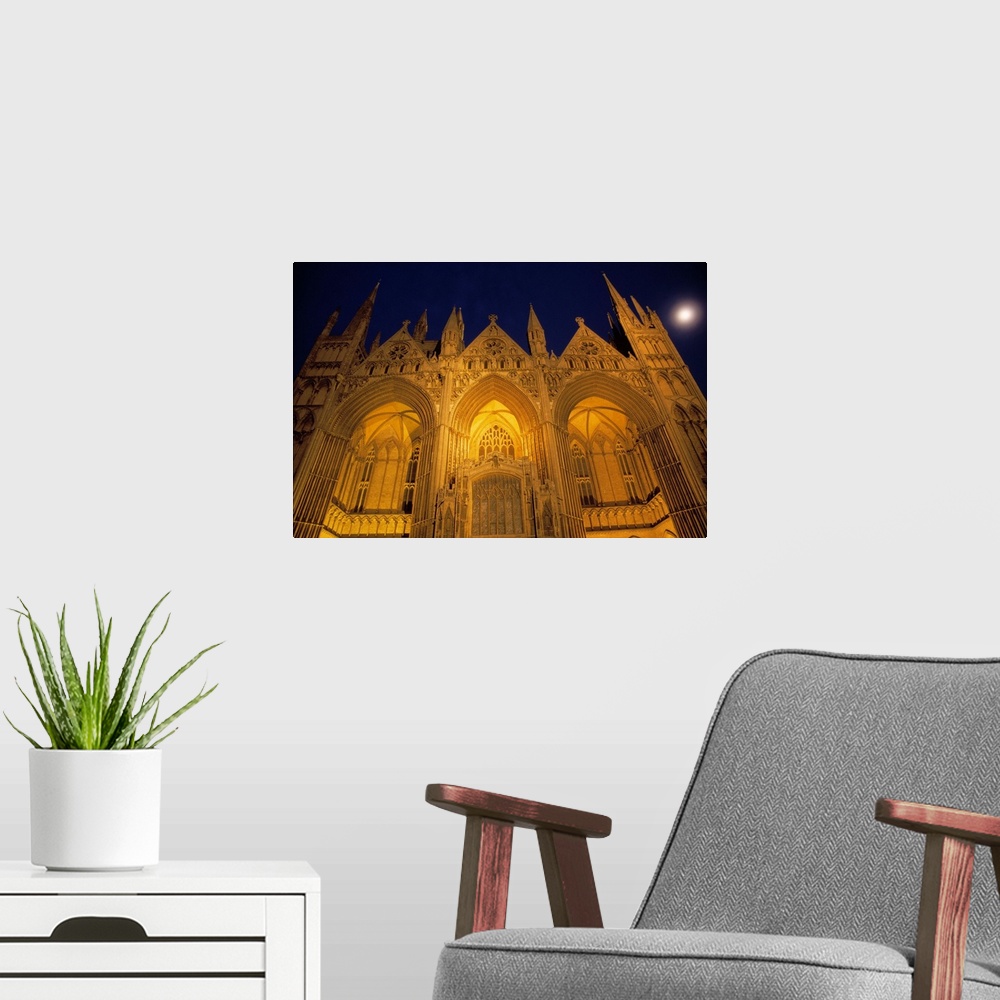 A modern room featuring Low-angle view of Peterborough Cathedral illuminated at night, Peterborough, England.