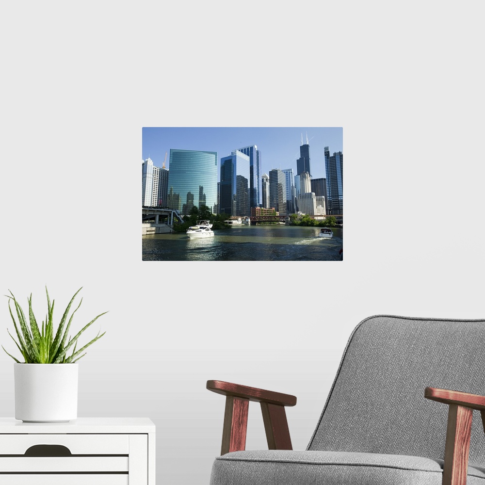 A modern room featuring Low-angle view of buildings and skyline with waterfront filled with boats.