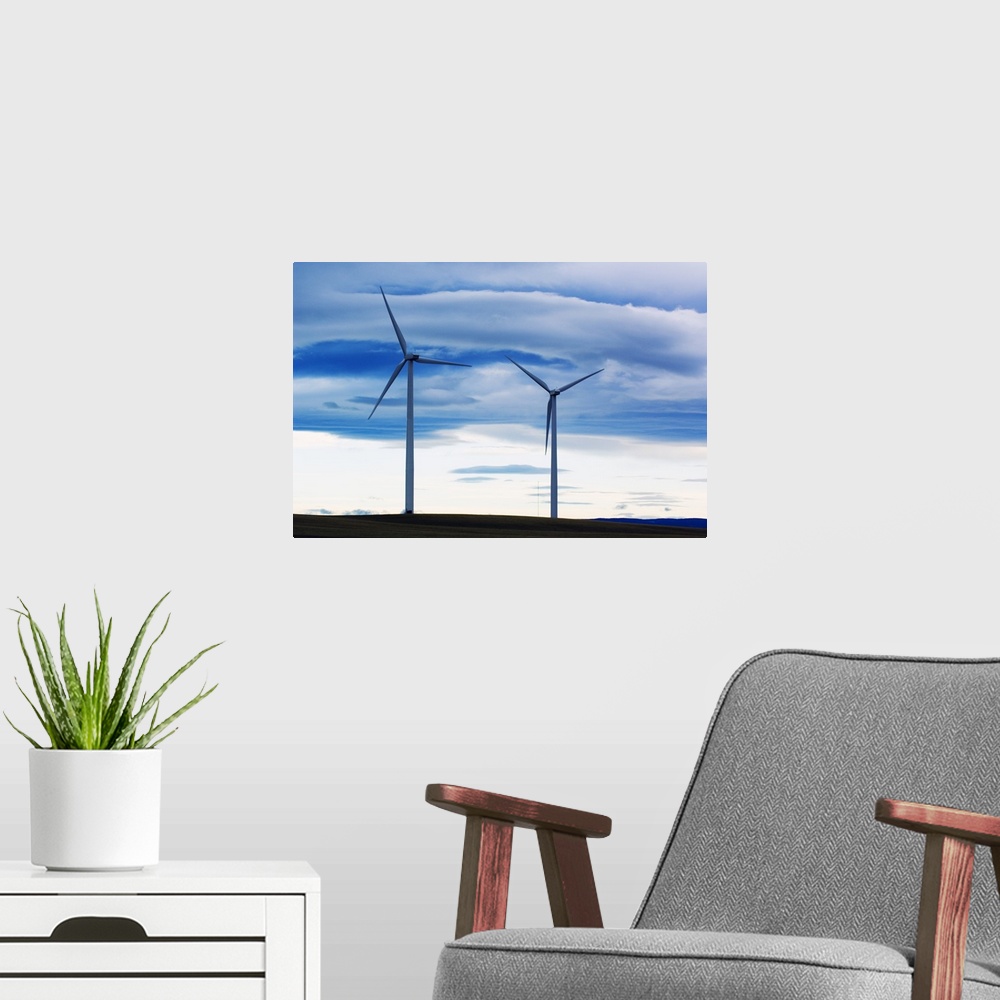 A modern room featuring Pair of wind farm turbines, cloudy sky, Montana