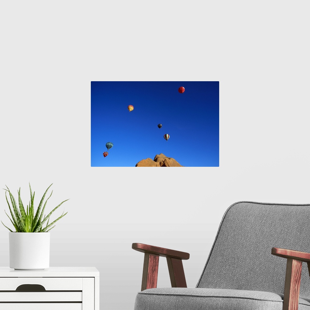 A modern room featuring Red rock cliffs, hot air balloons in blue sky, Gallup, New Mexico
