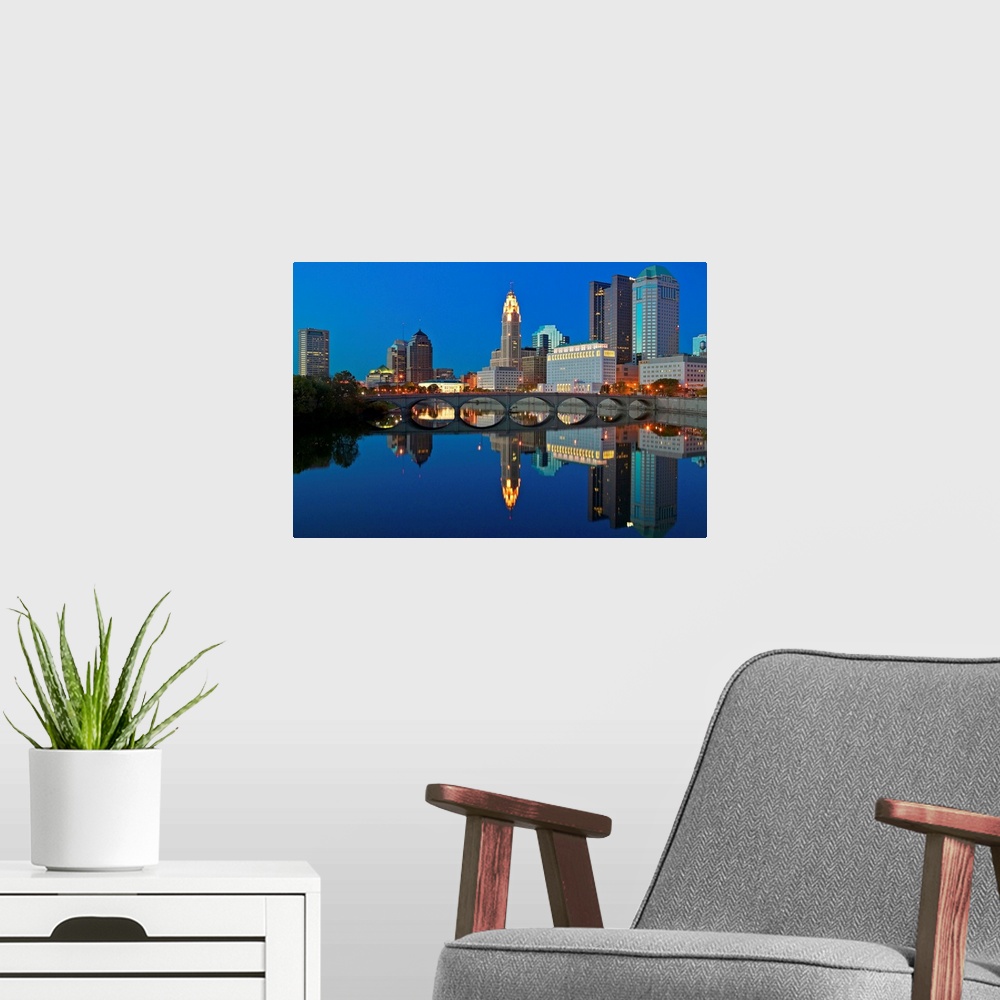 A modern room featuring Scioto River and Columbus Ohio skyline at dusk