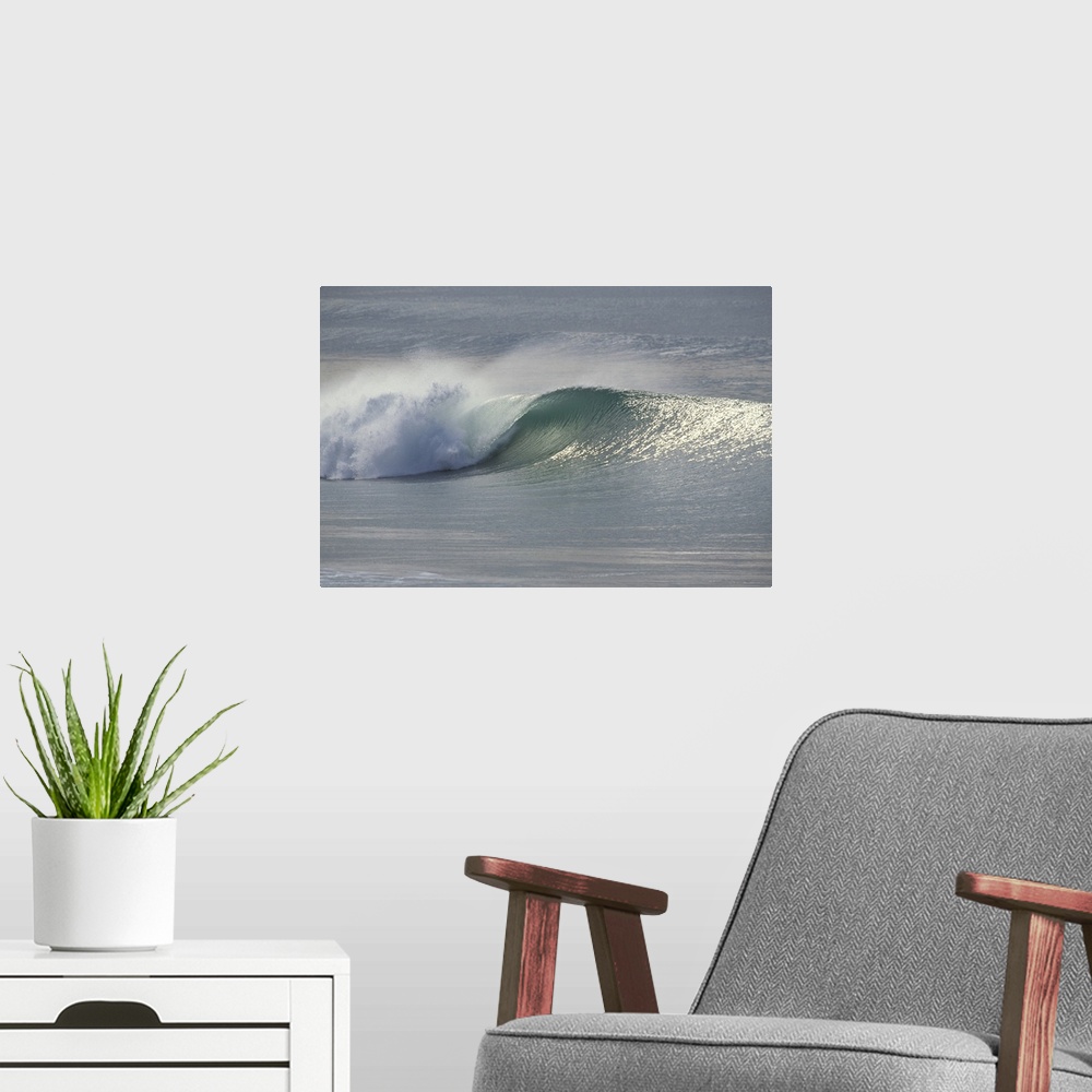 A modern room featuring This landscape photograph shows an ocean wave breaking on the shore.