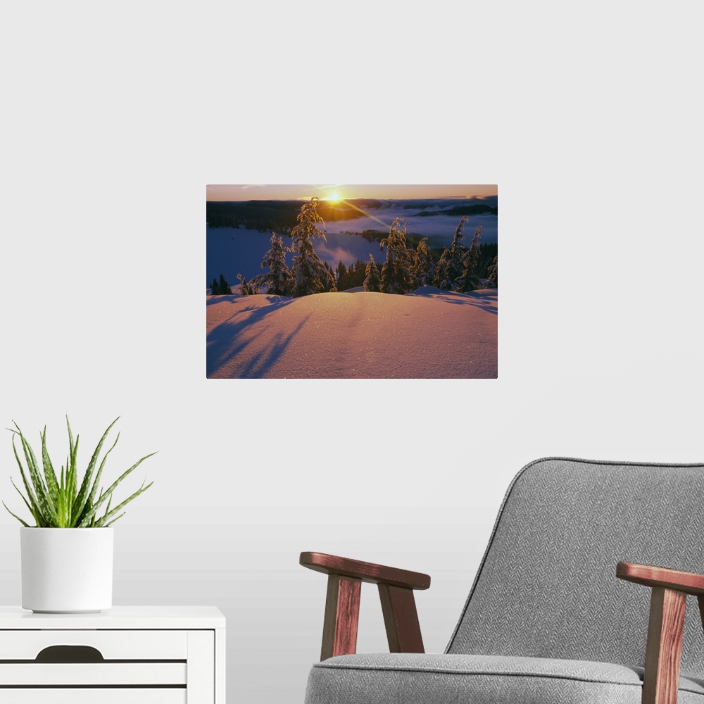 A modern room featuring This dramatic landscape photograph captures the sun ascending over the mountain ridge and illumin...