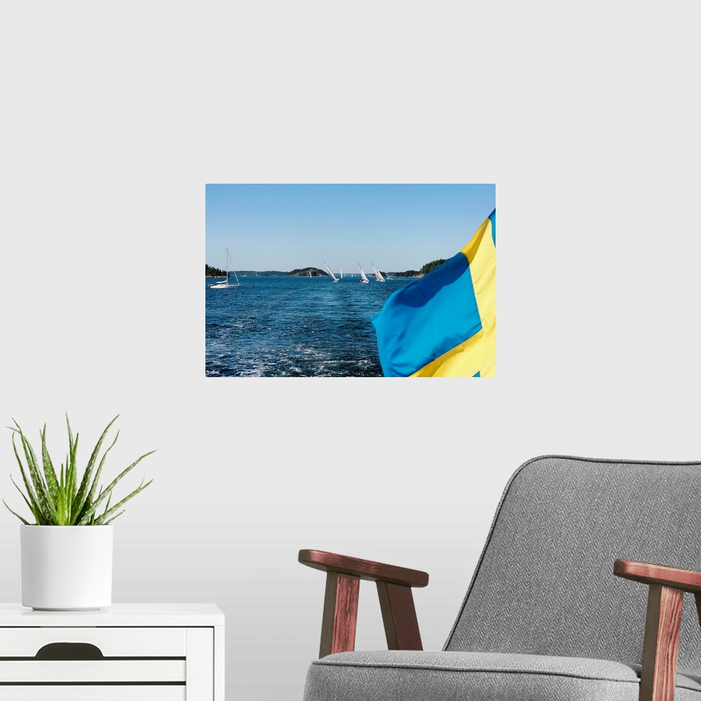 A modern room featuring Close-up of a Swedish flag with sailboats in the background, Stockholm Archipelago, Stockholm, Sw...