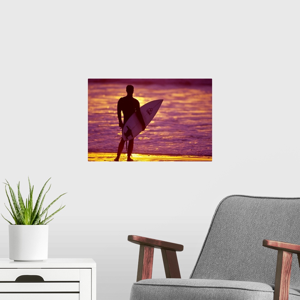 A modern room featuring Male surfer on the beach in San Diego, CA