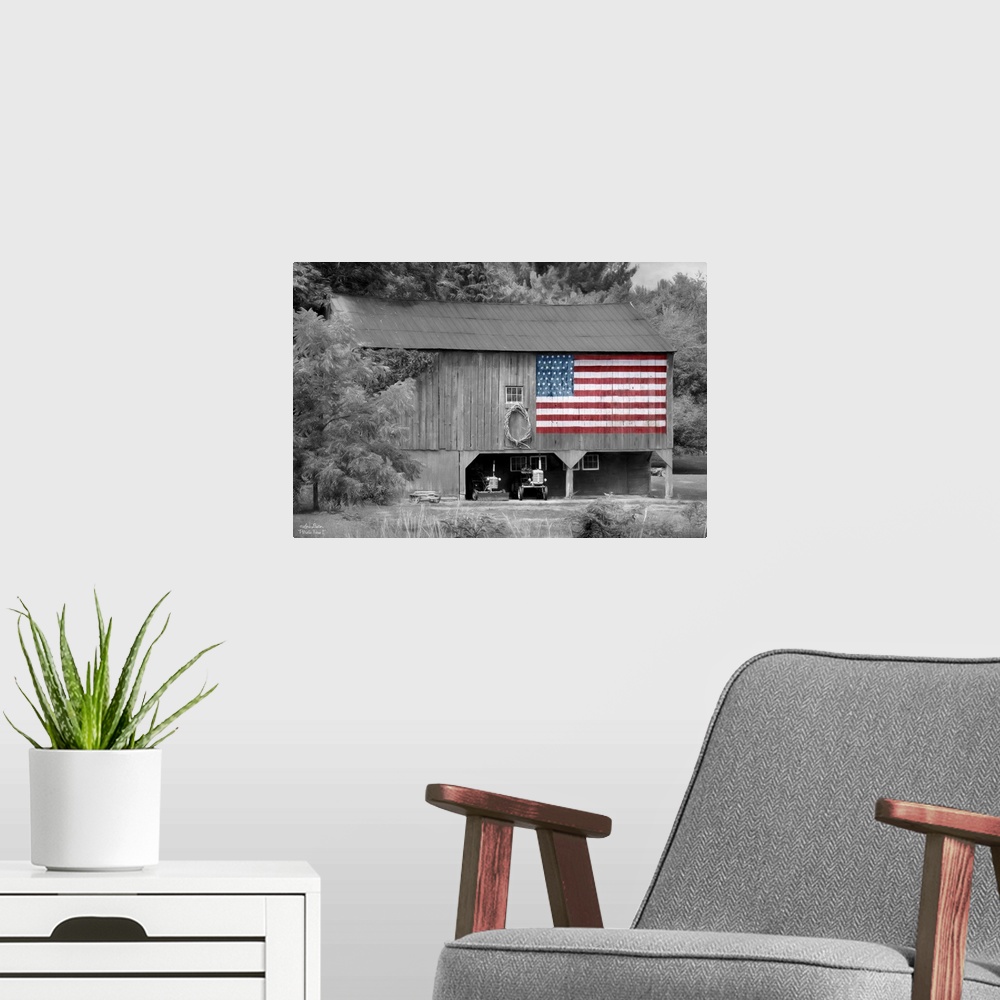 A modern room featuring Black and white photo of a barn with an American Flag in color painted on the side.