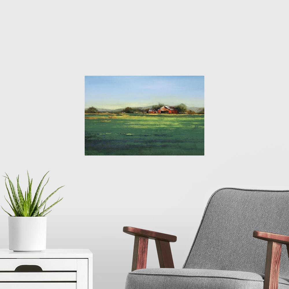 A modern room featuring Contemporary artwork of a farm landscape with a green field.