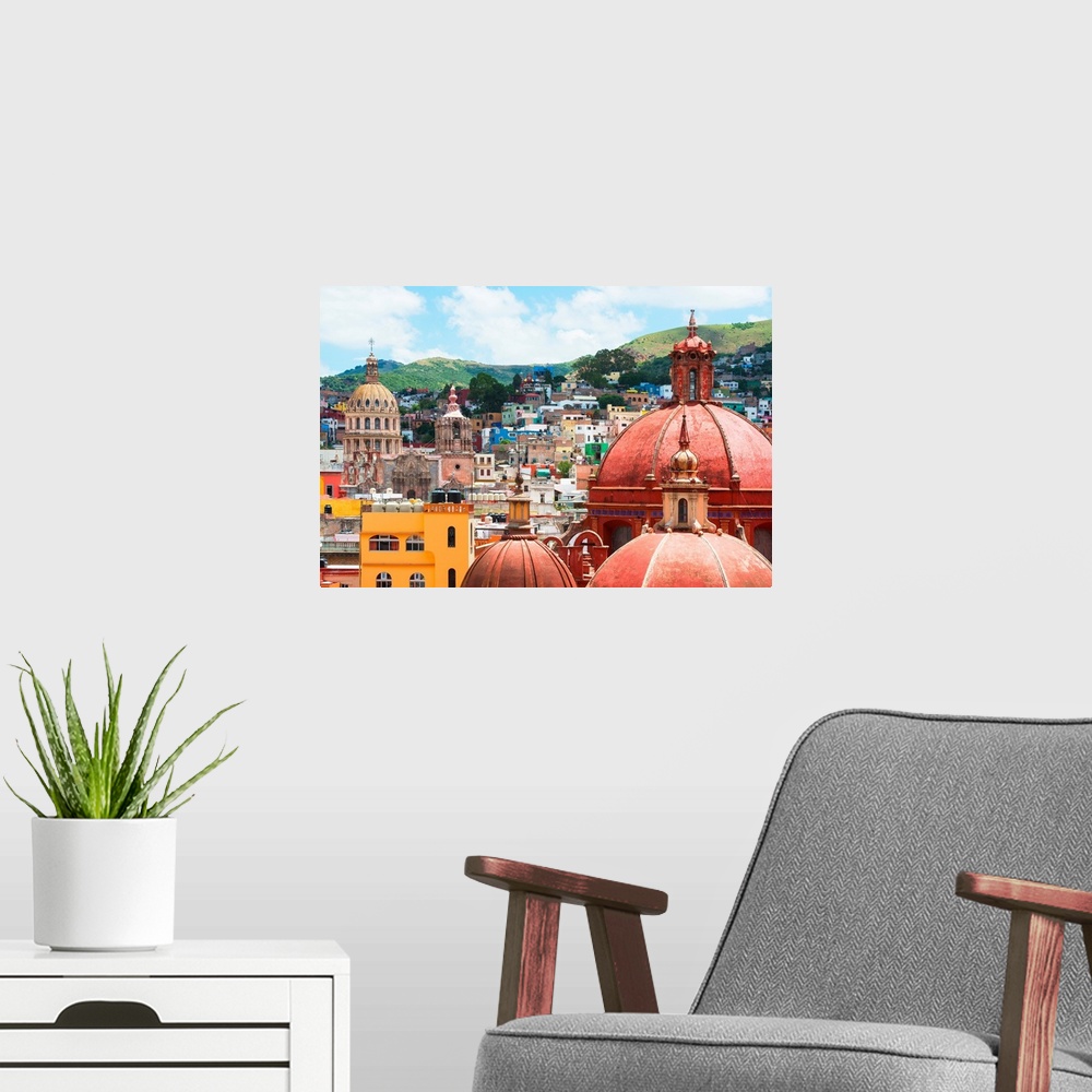 A modern room featuring Cityscape photograph of colorful buildings and several church domes in Guanajuato, Mexico. From t...