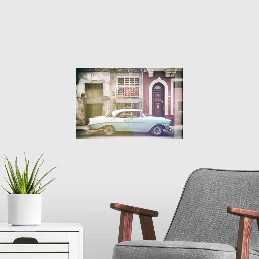 A modern room featuring Faded photograph of a turquoise and white vintage card parked on the side of a street in Havana w...