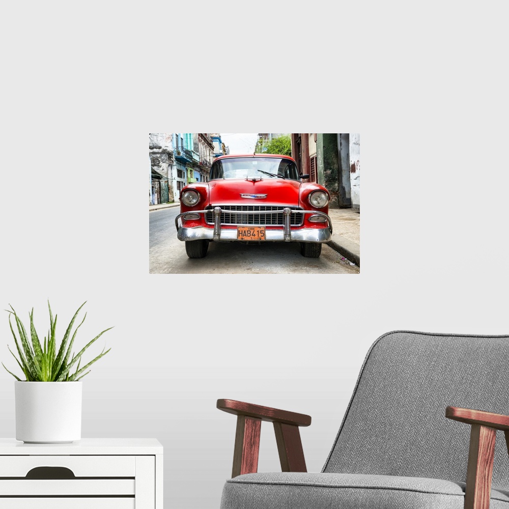 A modern room featuring Photograph of the front of a red vintage Chevrolet.