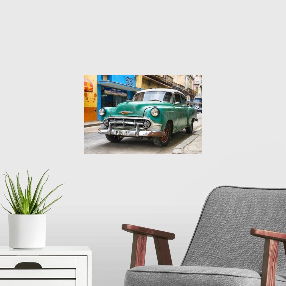 A modern room featuring Photograph of the front of a green vintage Chevrolet.