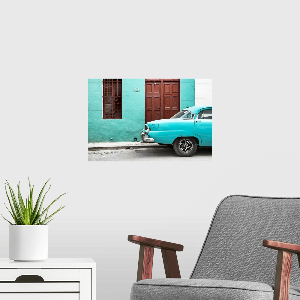 A modern room featuring Photograph of the back of a turquoise vintage car next to a matching facade with a dark wooden do...