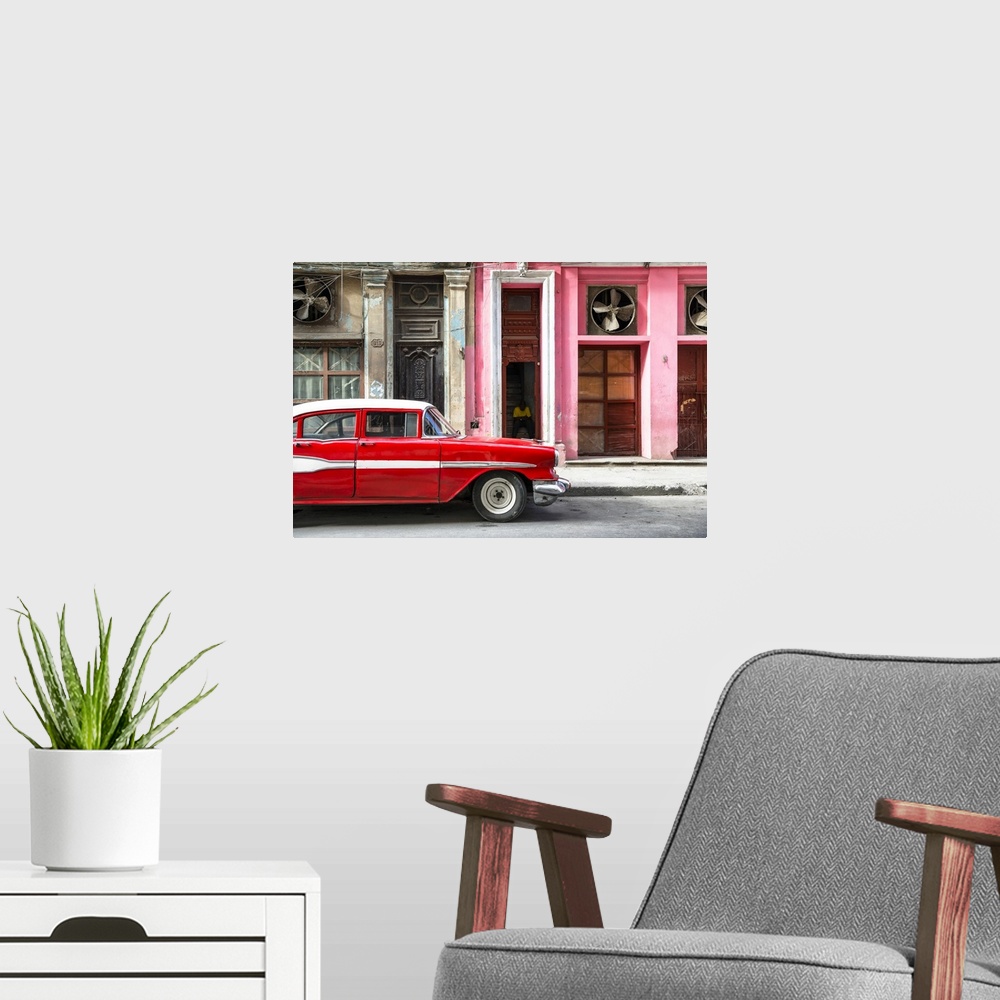 A modern room featuring Photograph of a classic old red car in front of a pink facade in Havana, Cuba.