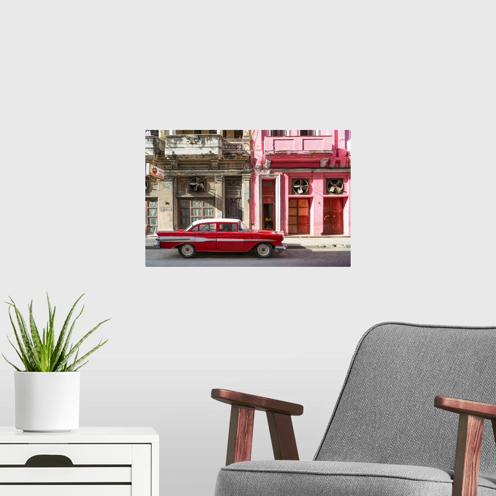 A modern room featuring Photograph of a red vintage car with white details parked in the street, Havana, Cuba