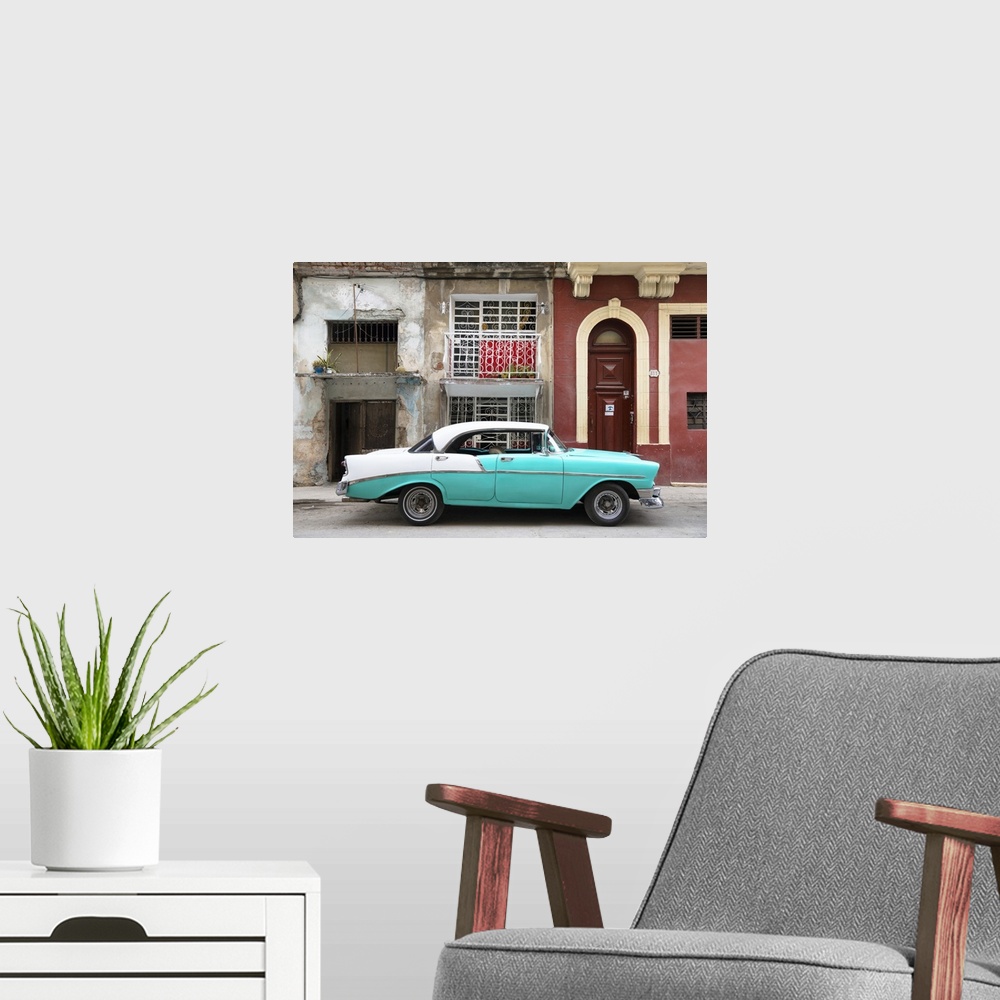 A modern room featuring Photograph of a turquoise and white vintage card parked on the side of a street in Havana with we...