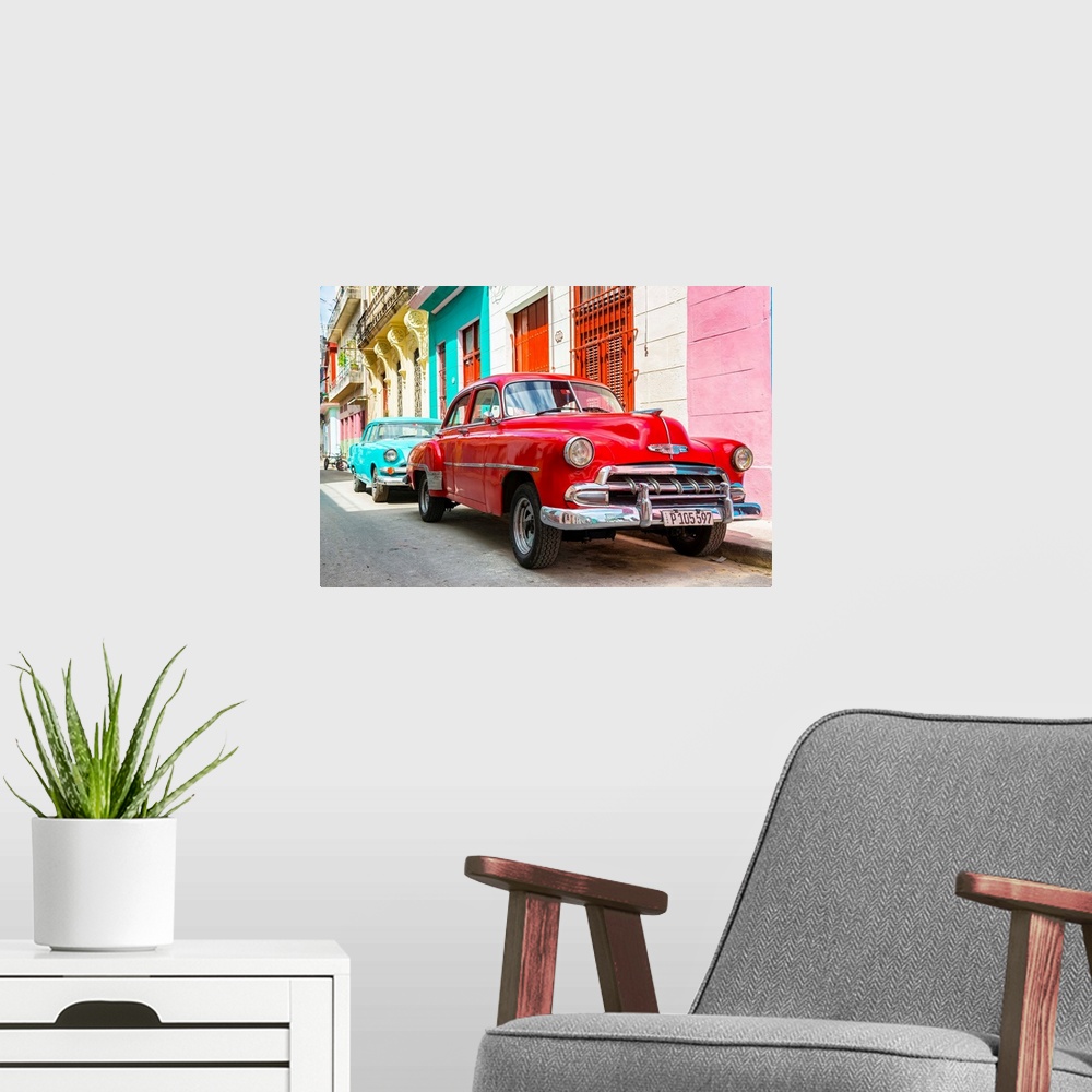 A modern room featuring Photograph of a turquoise and a red vintage Chevrolets parked along a colorful Havana street scene.