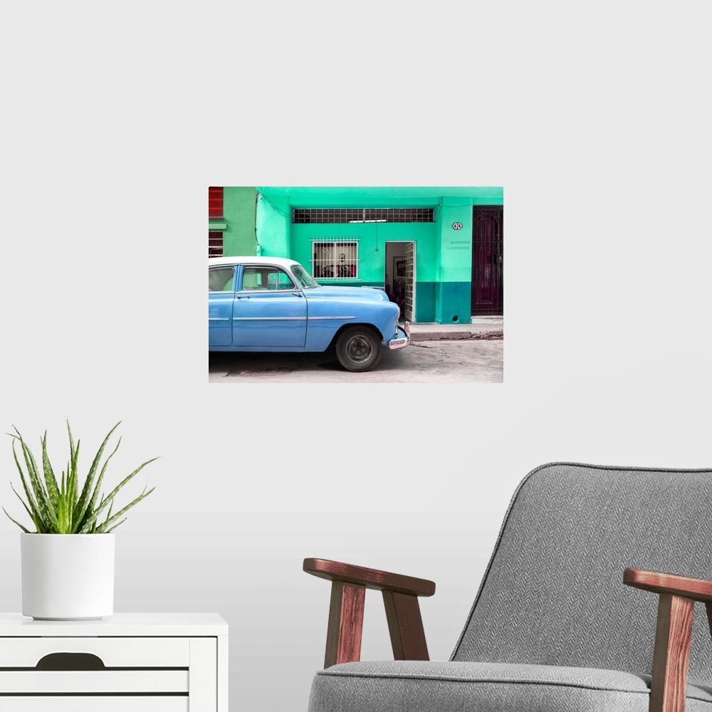 A modern room featuring Photograph of a blue vintage car parked on the road in Havana.