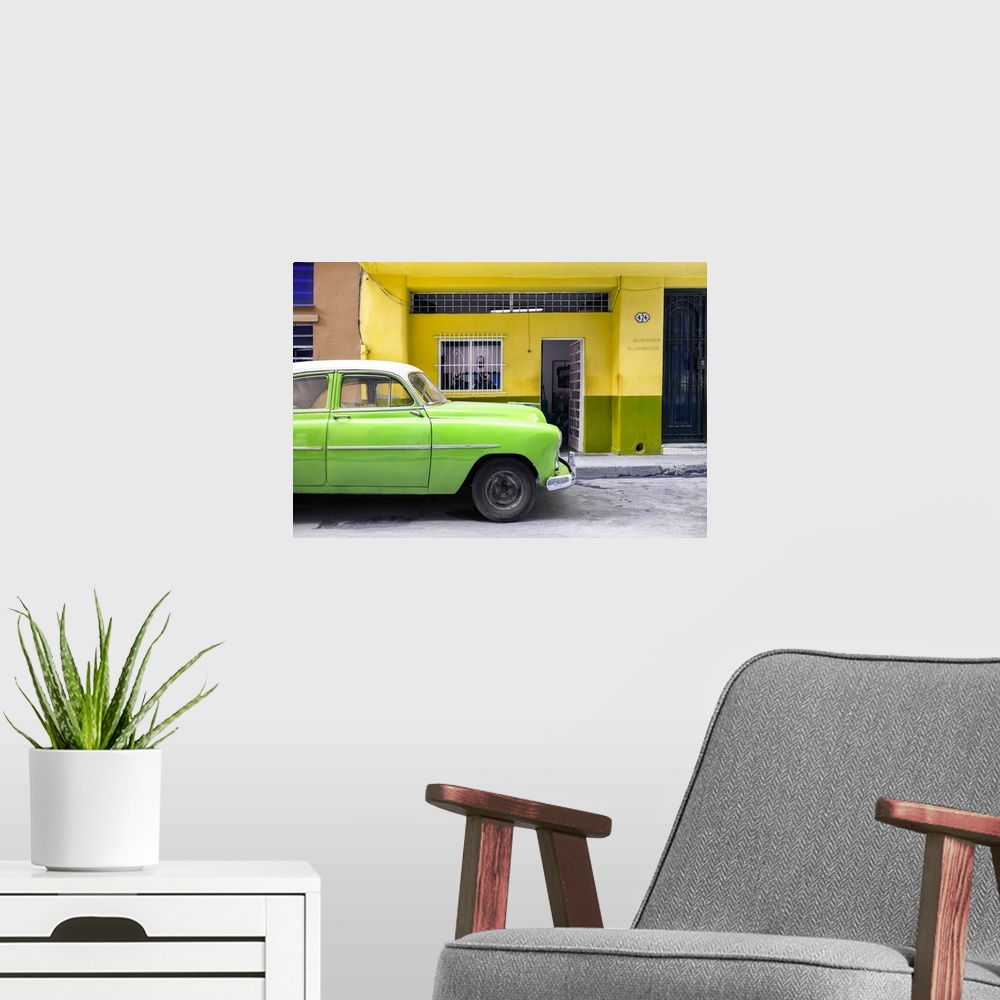 A modern room featuring Photograph of a bright green vintage car parked on the road in Havana with a bright yellow facade...