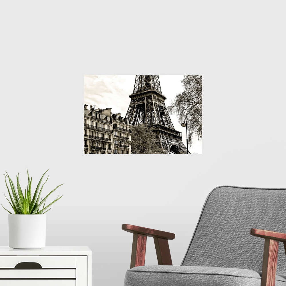 A modern room featuring Fine art photograph of the Eiffel Tower in France, with trees and buildings in the foreground.