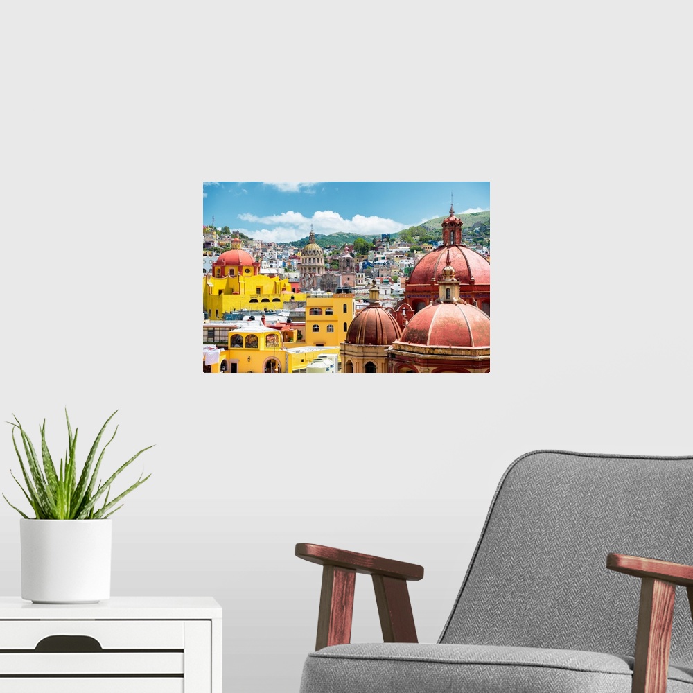 A modern room featuring Photograph of a cityscape in Guanajuato, Mexico, highlighting the colorful buildings and church d...