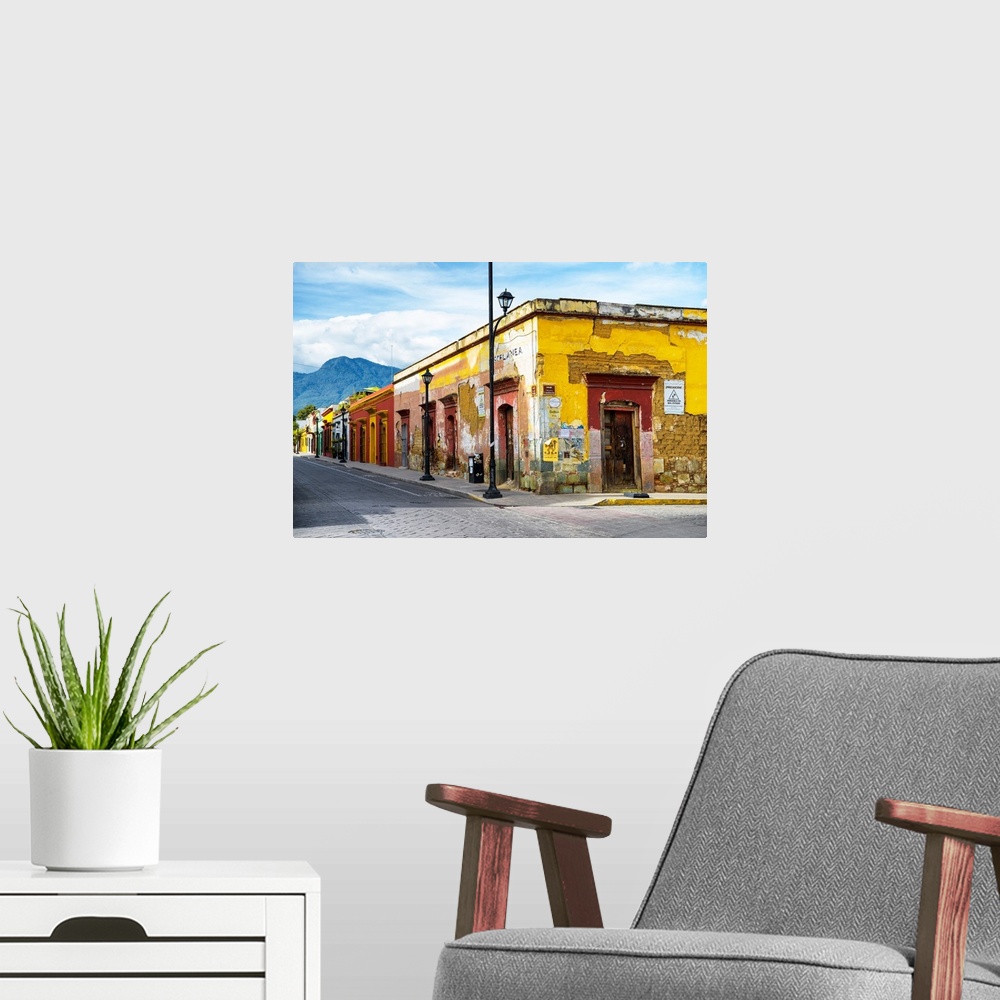 A modern room featuring Photograph of a bright city street in Oaxaca, Mexico, with a view of mountains in the background....
