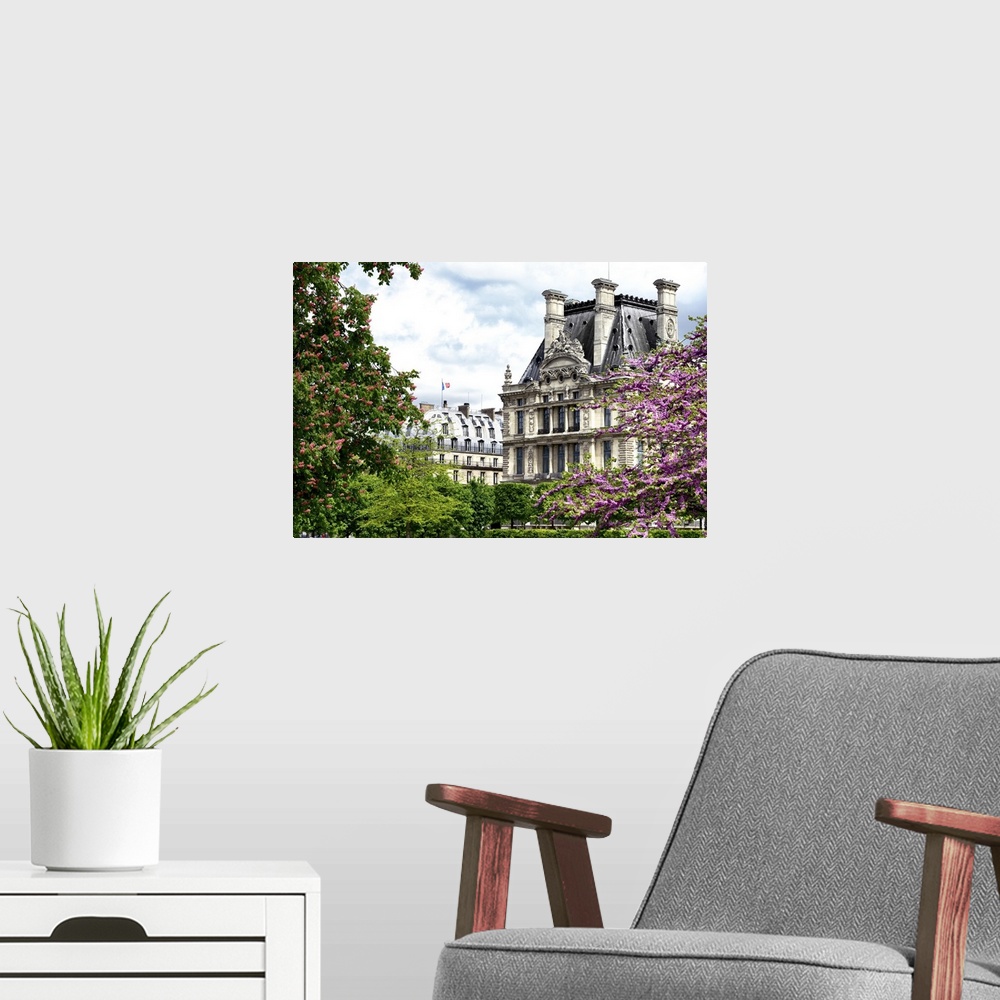 A modern room featuring Trees in full bloom frame classic French architecture on a beautiful spring day.