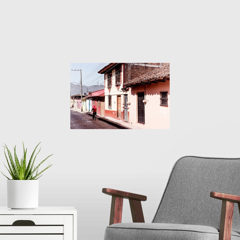 A modern room featuring Photograph of a streetscape in Mexico with a man in red riding a bike down the road. From the Viv...